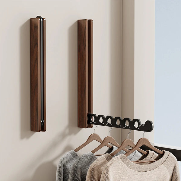 Two foldable wall-mounted clothes hanger racks with one arm extended